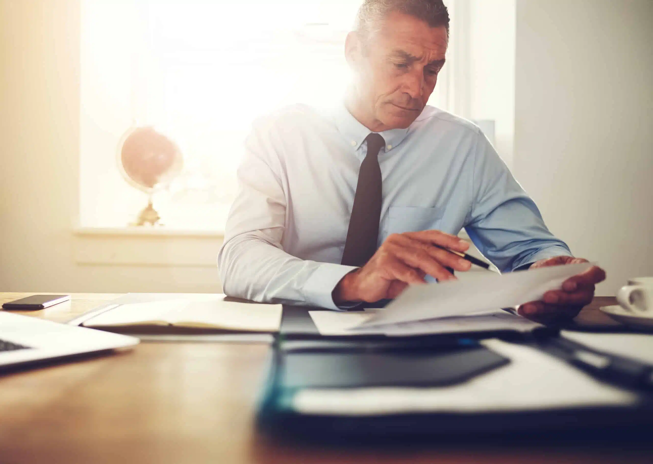 Focused,Mature,Businessman,Wearing,A,Shirt,And,Tie,Sitting,At 218 scaled 1